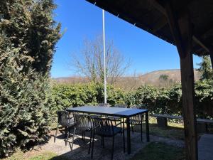 a table and chairs sitting under a gazebo at Weingut Martin Blaß in Erlabrunn