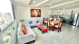 a living room with a white couch and a table at KattyApartament1102 in Salinas