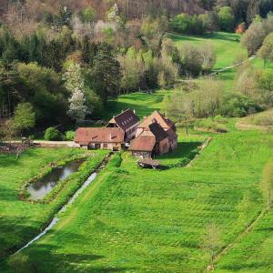 an aerial view of a house in a field at Maison d'hôtes complète La Paulusmühle in Soucht