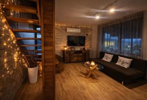 a living room with a couch and a television at ng royal in Rakitovo