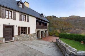 a large white house with a large driveway at L'Ancienne Poste Exclusive Alpine Chalet in Avajan