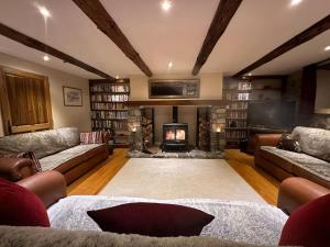 a large living room with couches and a fireplace at L'Ancienne Poste Exclusive Alpine Chalet in Avajan