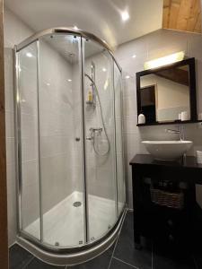 a bathroom with a shower and a sink at L'Ancienne Poste Exclusive Alpine Chalet in Avajan +19 photos