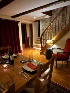 a wooden table with wine glasses on top of it at L'Ancienne Poste Exclusive Alpine Chalet in Avajan
