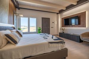 a large bedroom with a large bed and a flat screen tv at Alfiri 890 in Santa Maria Pietrafitta