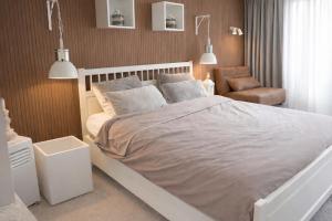 a bedroom with a large bed and a chair at Landgoed Rotermundt in Huijbergen