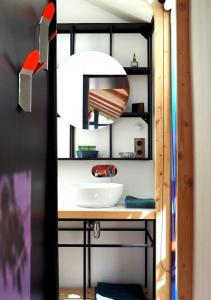 a bathroom with a sink and a mirror at Designer Cabin With Shared Pool In Bras in Bras