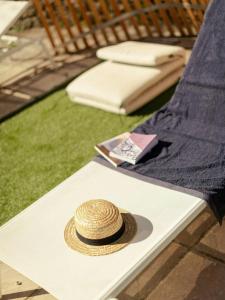 a straw hat sitting on a white table at Designer Cabin With Shared Pool In Bras in Bras +7 photos