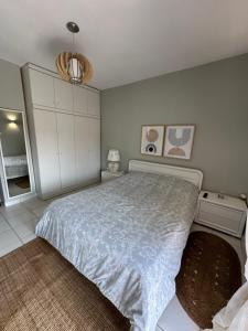 a bedroom with a large bed and white cabinets at Toroni home in Toroni