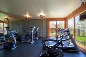 a gym with several tread machines in a room with windows at Powder Peak Hideaway WL203 Ski Escape Hot Tub in Eden