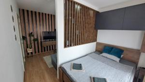 a bedroom with a bed with blue pillows at Apartman Brankovic in Jagodina