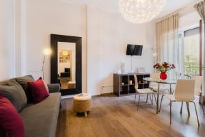 a living room with a couch and a table at Mazzini Urban Apartment - Lecce Selection in Lecce +11 photos