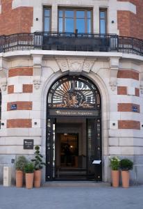 an entrance to a building with potted plants in front at Hotel & Spa Oceania Lille Les Augustins in Lille