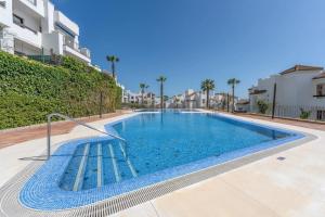 a swimming pool in the middle of a building at Spacious 6-bed Apartment in Marina de la Alcaidesa in La Alcaidesa