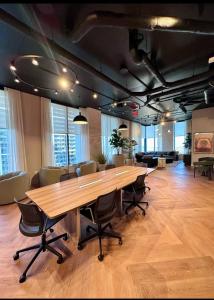 an office with a large wooden table and chairs at 501 First Residences Miami in Miami +27 photos
