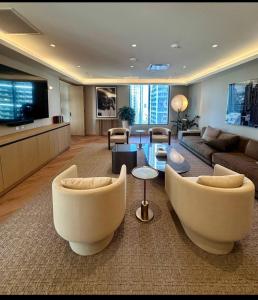 a large living room with couches and a tv at 501 First Residences Miami in Miami
