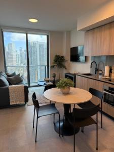 a kitchen and living room with a table and chairs at 501 First Residences Miami in Miami