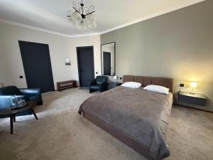 a bedroom with a bed and a living room at U Dominicana in Kamianets-Podilskyi