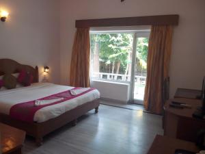 a bedroom with a bed and a large window at The Backpacker hostel by Surendra rajak in Khajurāho