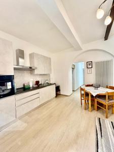 a kitchen with a table and a dining room at Casa in Centro con Giardino in Imola