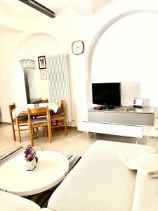 a living room with a couch and a table at Casa in Centro con Giardino in Imola