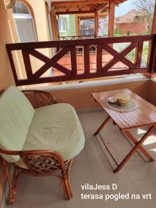 a chair and a table on a balcony at Vila Konak podno grejanje in Veliko Gradište +28 photos