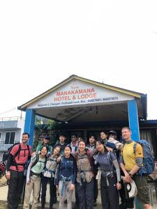 a group of people standing in front of a building at Hotel New Manakamana in Pāti Bhanjyāng