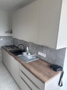 a kitchen with a sink and a counter top at Apartment Centrum in Lučenec