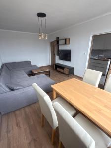 a living room with a bed and a table and chairs at Apartment Centrum in Lučenec