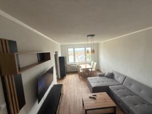 a living room with a couch and a table at Apartment Centrum in Lučenec +1 photo