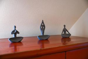three metal figurines sitting on top of a wooden table at Design Ferienhaus Kamerun an der Elbe in Damnatz