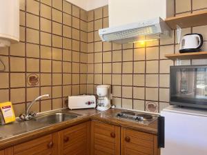 a small kitchen with a sink and a microwave at Basic Comfort Studio Poblat tipic 0167 in Empuriabrava