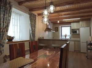 a kitchen with a large wooden table in a room at Casa Belén Javierre de Bielsa in Bielsa