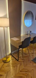 a desk with a chair and a mirror in a room at House Dado in Jezerce