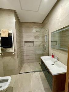 a bathroom with a shower and a sink and a toilet at Apparemment s1 vu sur mer et piscine in Zarzis