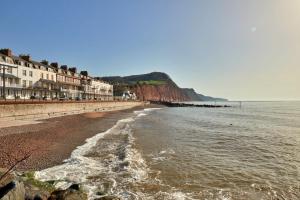 a view of the beach with buildings and the ocean at Finest Retreats - Centre View in Sidmouth