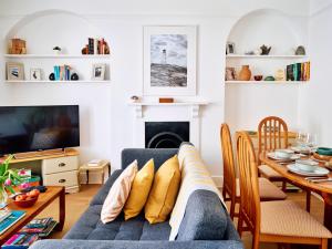 a living room with a couch and a table at Finest Retreats - Centre View in Sidmouth