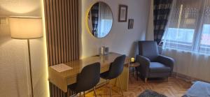 a room with a desk and two chairs and a mirror at House Dado in Jezerce +45 photos