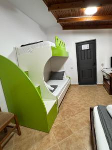 a green and white bunk bed in a room at Guest House Gerard in Ksamil