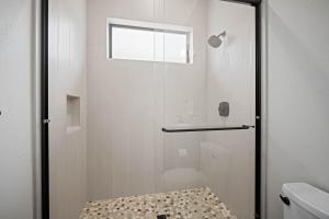 a shower with a glass door next to a toilet at 18171-2 Forestbrook Loop in Bend