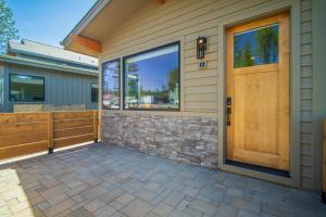 a home with a wooden door and a patio at 18171-2 Forestbrook Loop in Bend