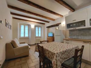 a kitchen and dining room with a table and a couch at B&B Ploncher in Chiavenna