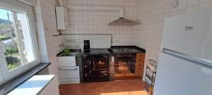 a kitchen with an oven and a stove at APARTAMENTO SUJARRERA in Villacarriedo