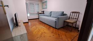 a living room with a couch and a chair at APARTAMENTO SUJARRERA in Villacarriedo