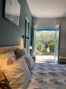 a bedroom with a bed and a door to a patio at La cerisaie in Montpellier