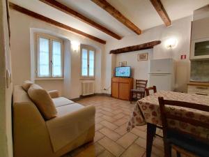 a living room with a couch and a table at B&B Ploncher in Chiavenna