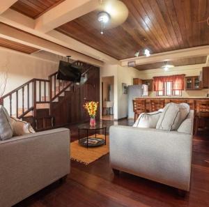 a living room with two couches and a kitchen at Careffe Escape Hideaway in Monchy