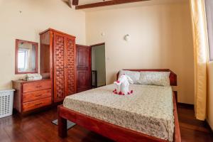 a bedroom with a bed with a stuffed animal on it at Careffe Escape Hideaway in Monchy