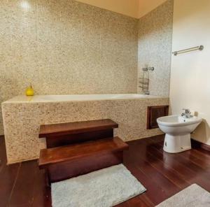 a bathroom with a tub and a toilet and a sink at Careffe Escape Hideaway in Monchy +8 photos
