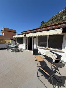 a patio with chairs and tables and a building at Terrazza in Manarola